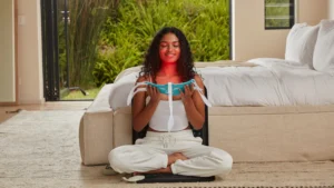 Woman using a red light therapy mask at home