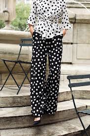 Polka dot blouse styled with tailored trousers for 2026
